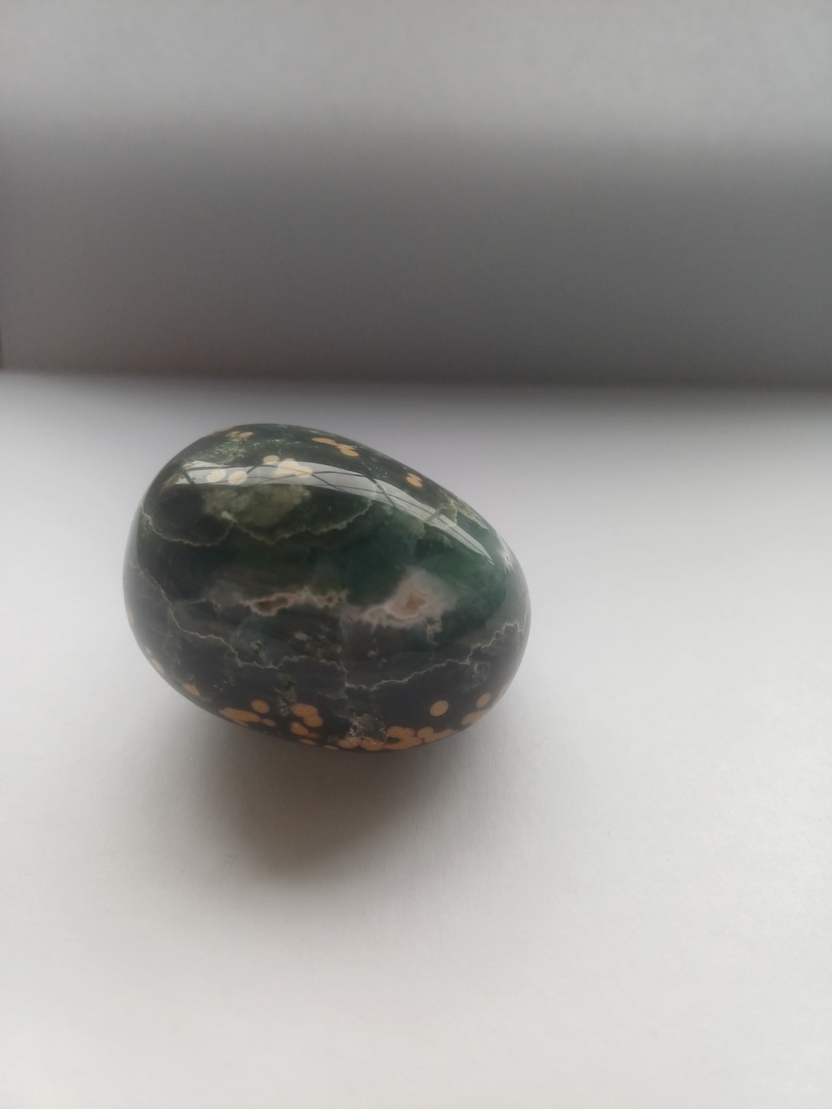 Ocean Jasper polished freeform side view showing dark green and cream banding