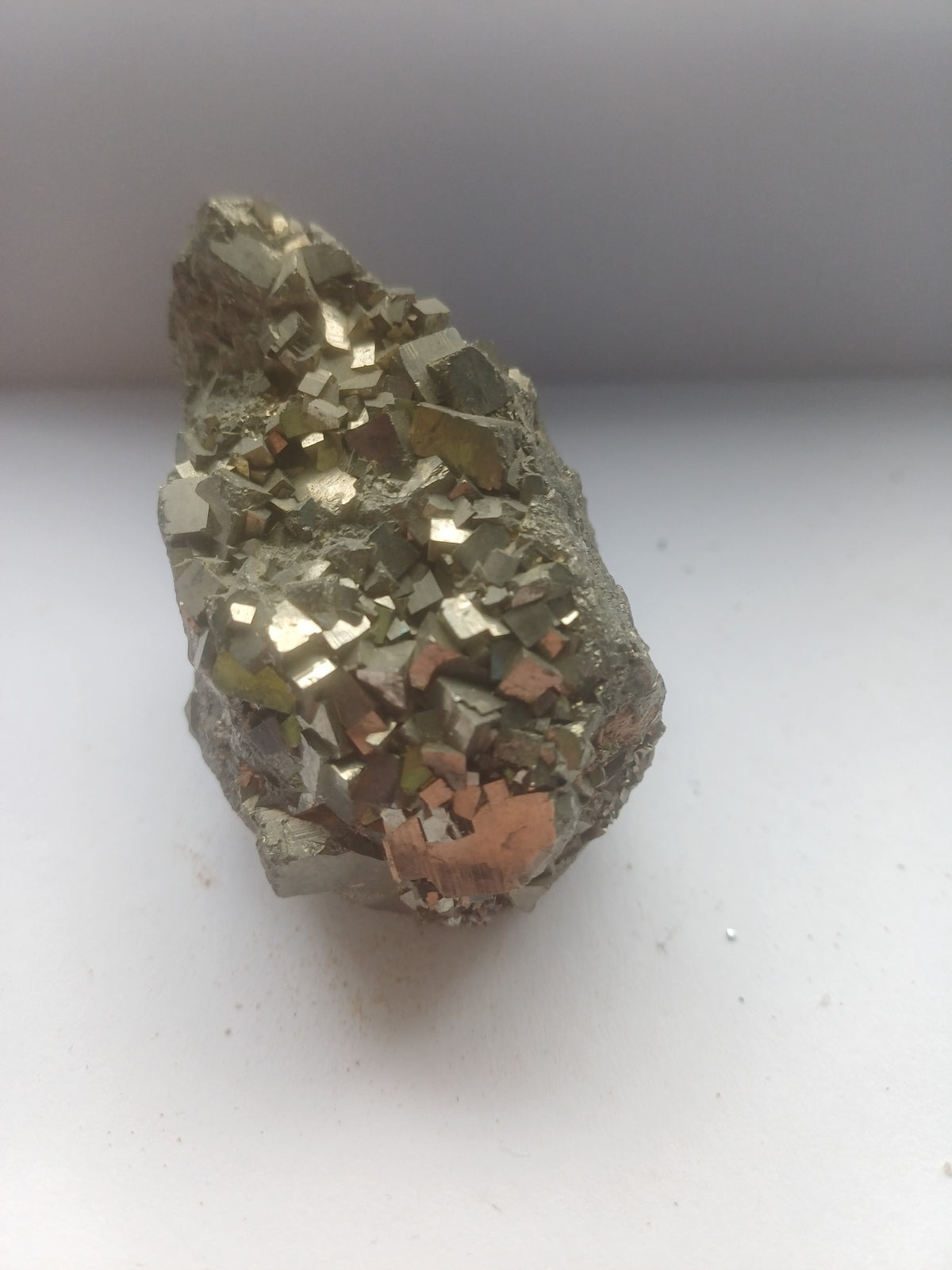 Natural pyrite specimen showing blocky metallic cubic crystal faces from the side