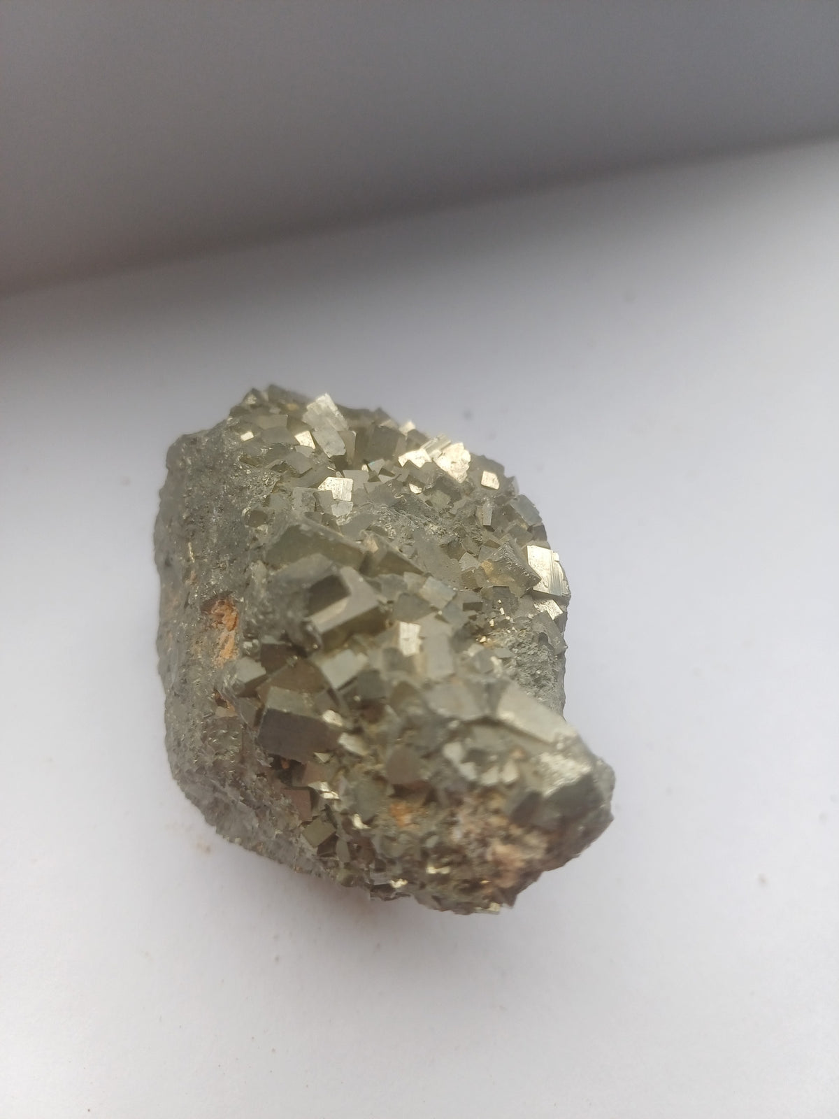 Close view of interlocking golden pyrite cubes and reflective metallic faces