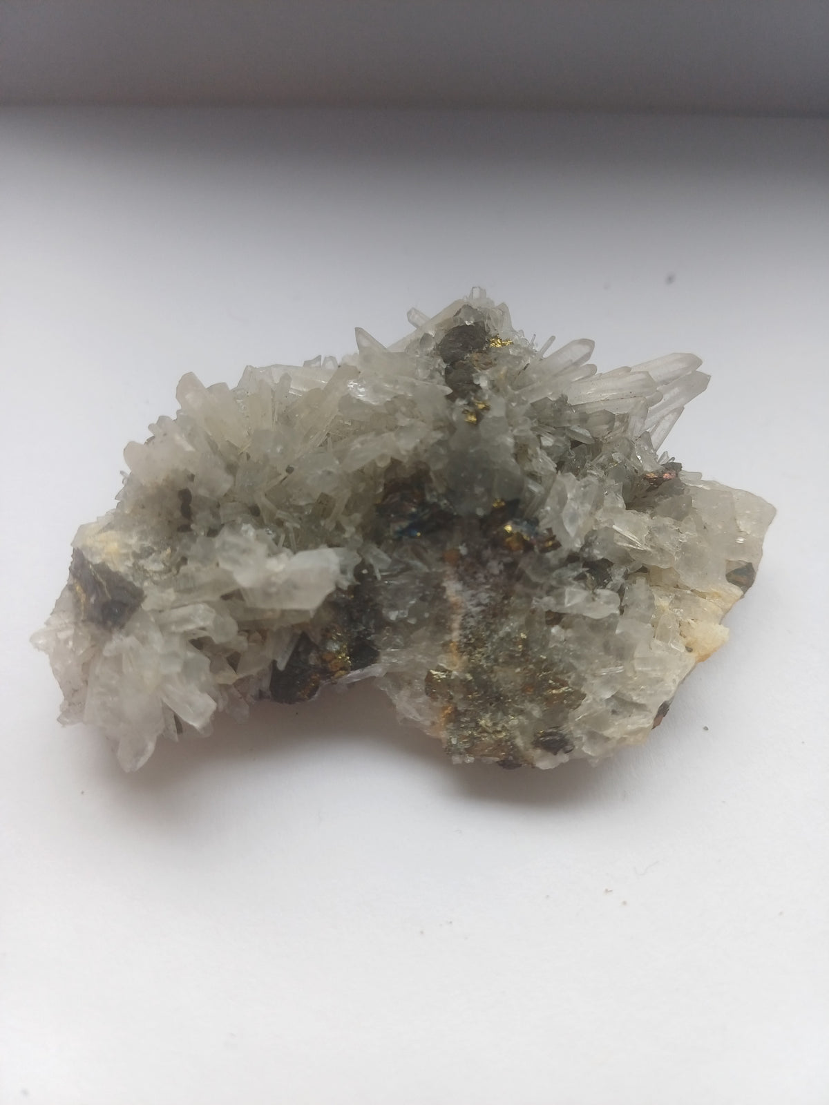 70mm mixed mineral specimen showing quartz points and brassy metallic mineralisation